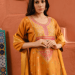 Pair with statement meenakari jhumkas, a sleek bun or braid with gajra, and finish with a golden potli bag and embroidered juttis.